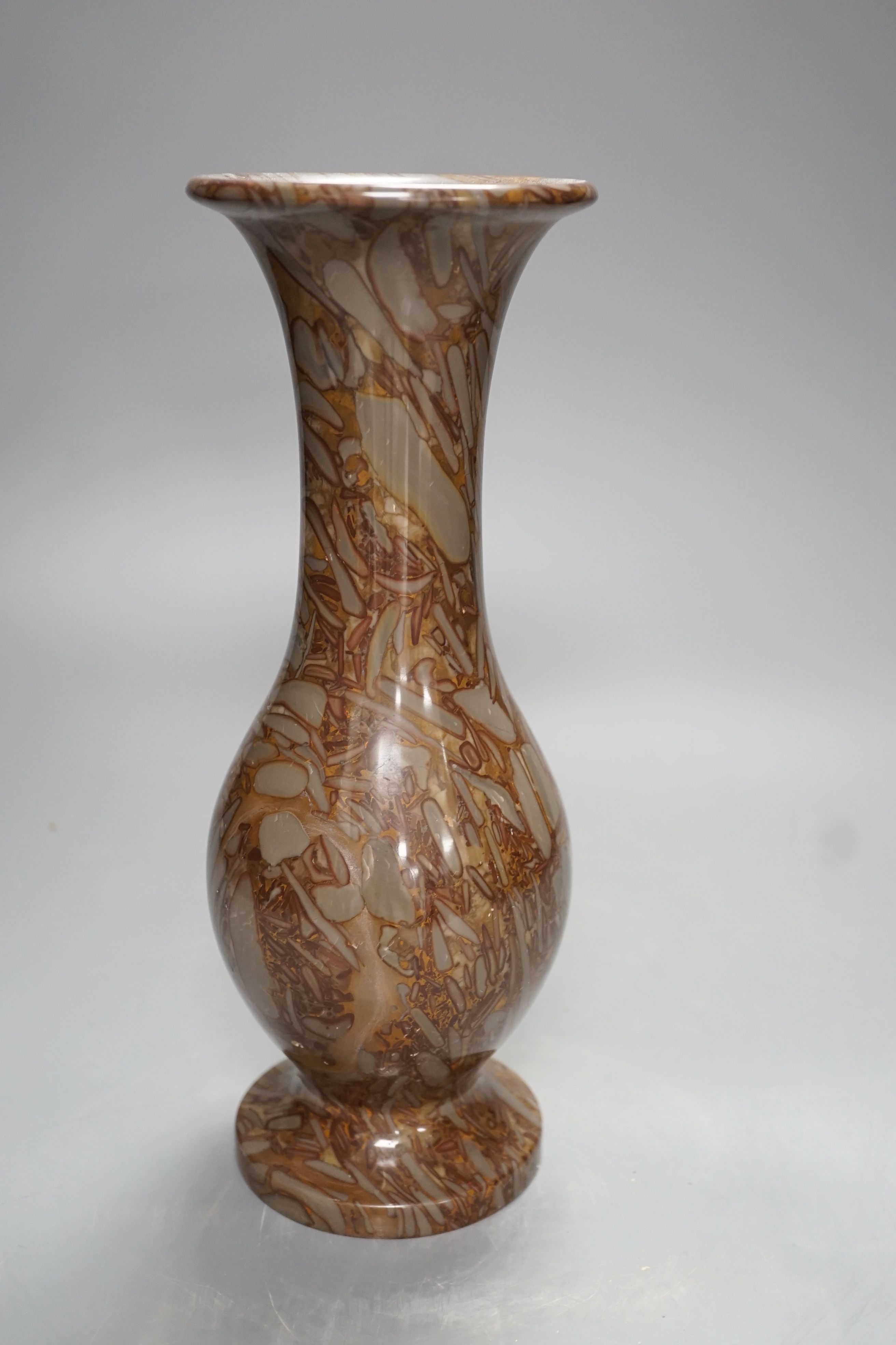 A pudding stone vase - 28cm high